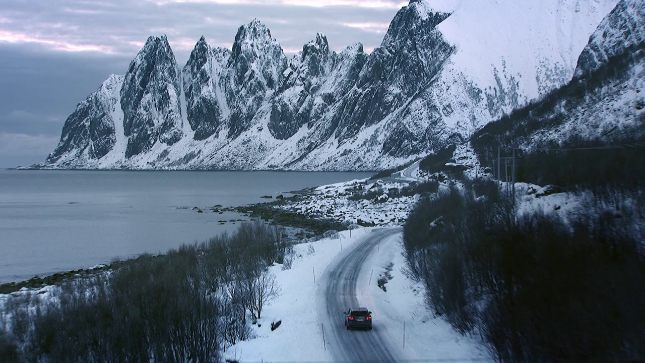 a car driving down a snow covered road