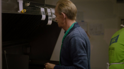 a man standing in front of a microwave oven