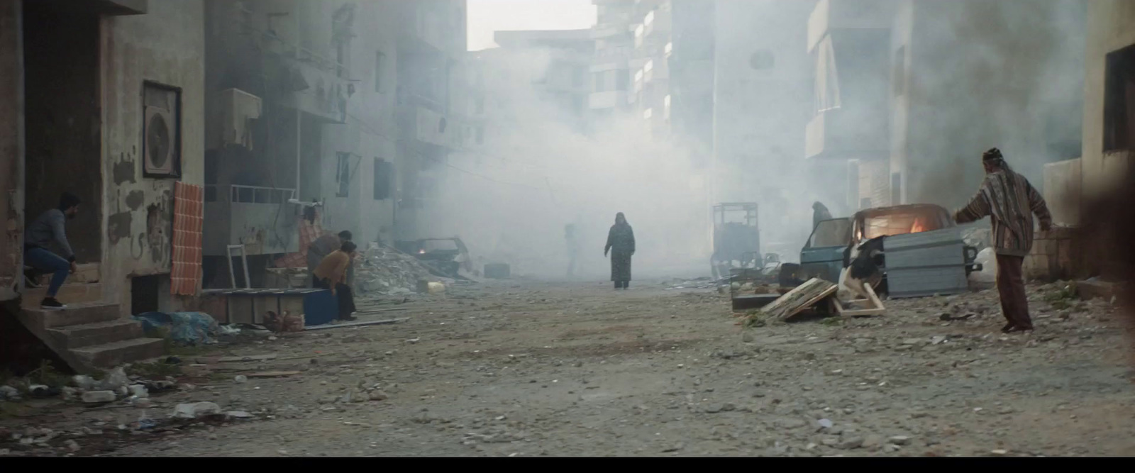 a group of people standing on a dirty street