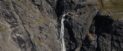 an aerial view of a waterfall in the mountains