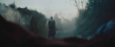 a blurry photo of a person standing in the fog