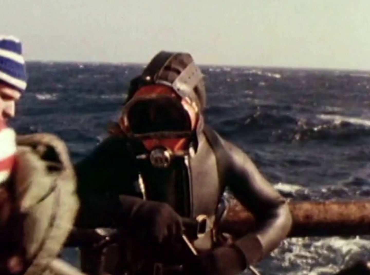 a man wearing a diving suit and a hat