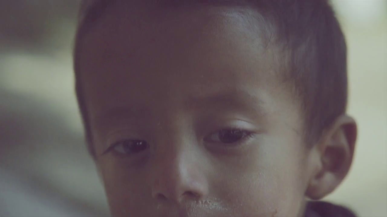 a close up of a child with a tooth brush in his mouth