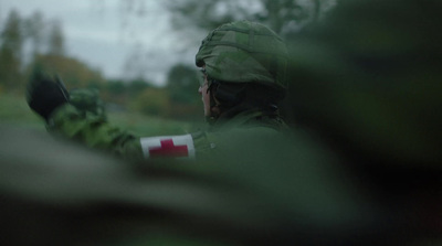 a man in a green uniform holding a gun