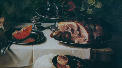 a table topped with plates of food next to a vase of flowers