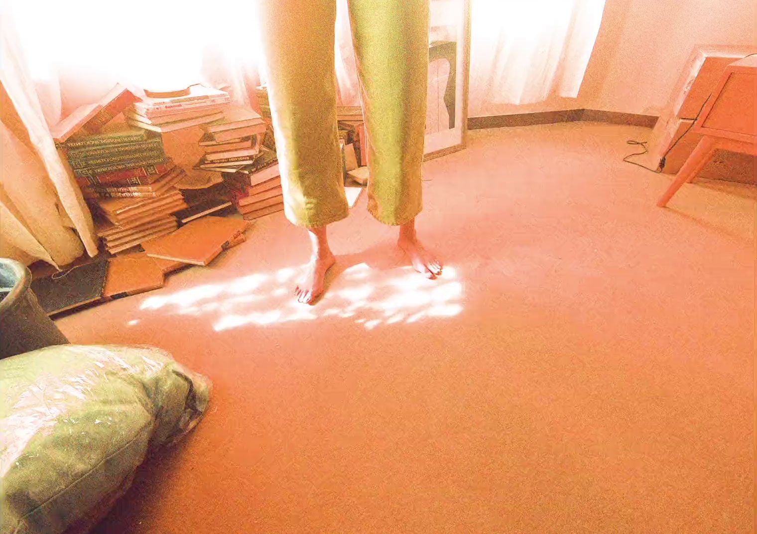 a person standing on a pink carpet in a room