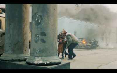 a group of people standing in front of a fire