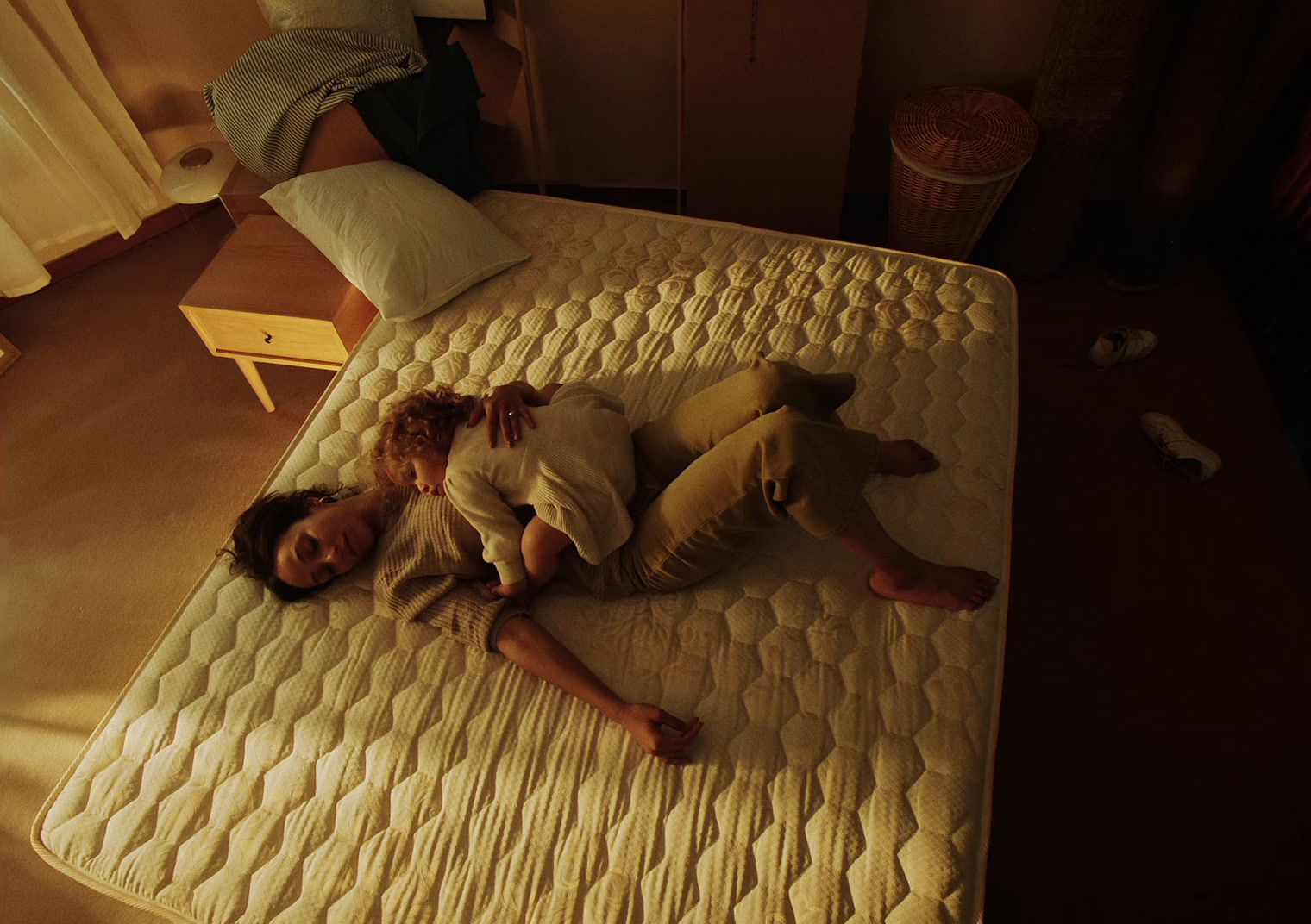 a man and a woman laying on a mattress