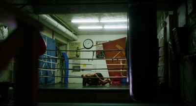 a person laying on the ground in a boxing ring