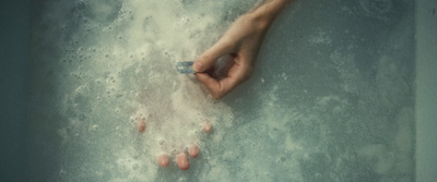 a person's feet in a bathtub filled with water