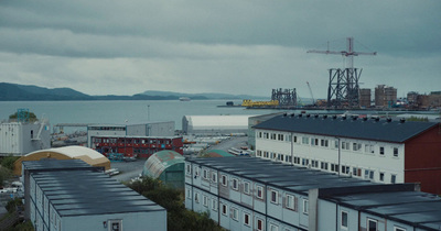 a view of some buildings and a body of water