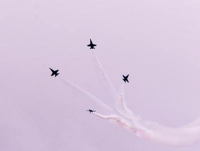 a group of jets flying through a cloudy sky