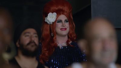 a woman with red hair and a flower in her hair