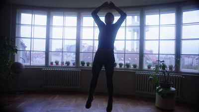 a person jumping in the air in front of a window