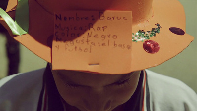 a person wearing a paper hat with writing on it