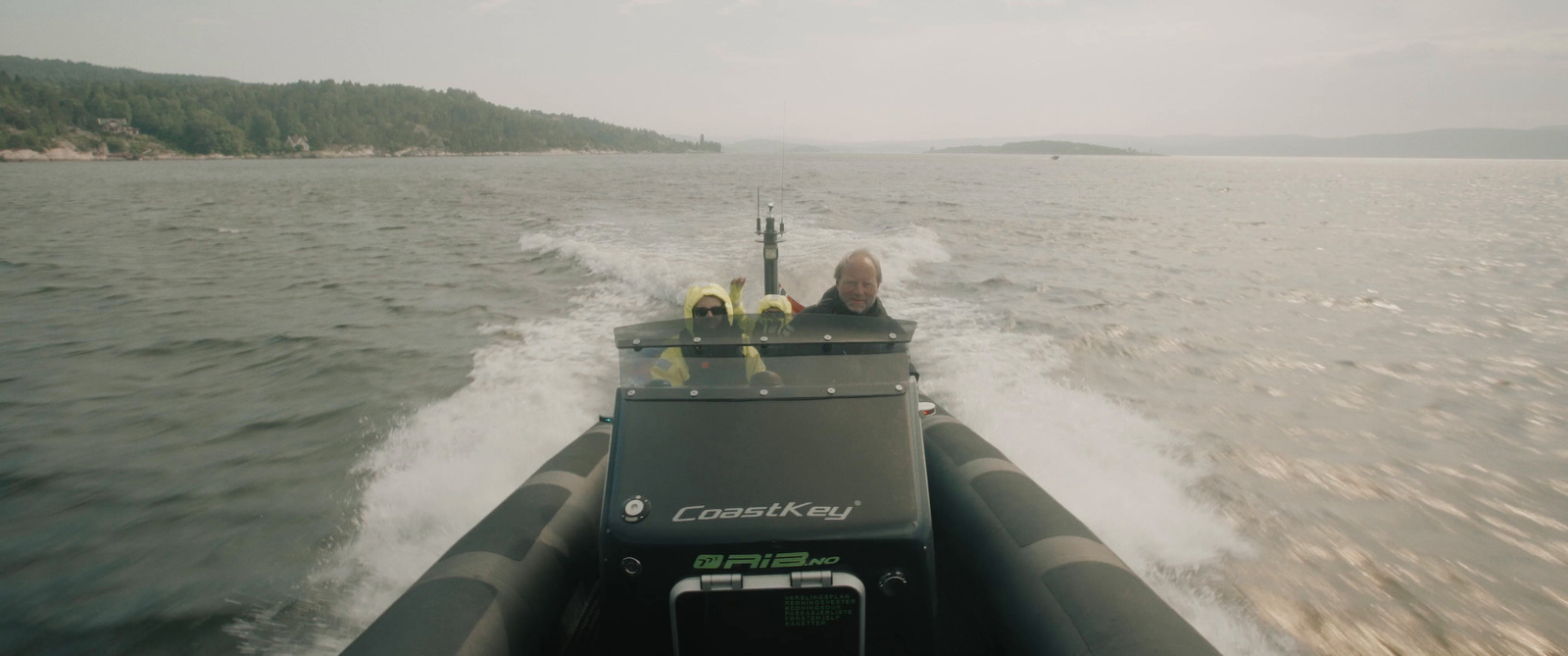 a person is driving a boat in the water