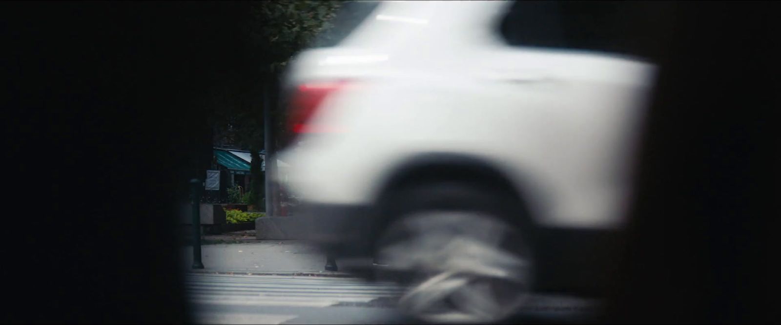 a blurry picture of a white truck on a city street