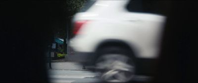 a blurry picture of a white truck on a city street