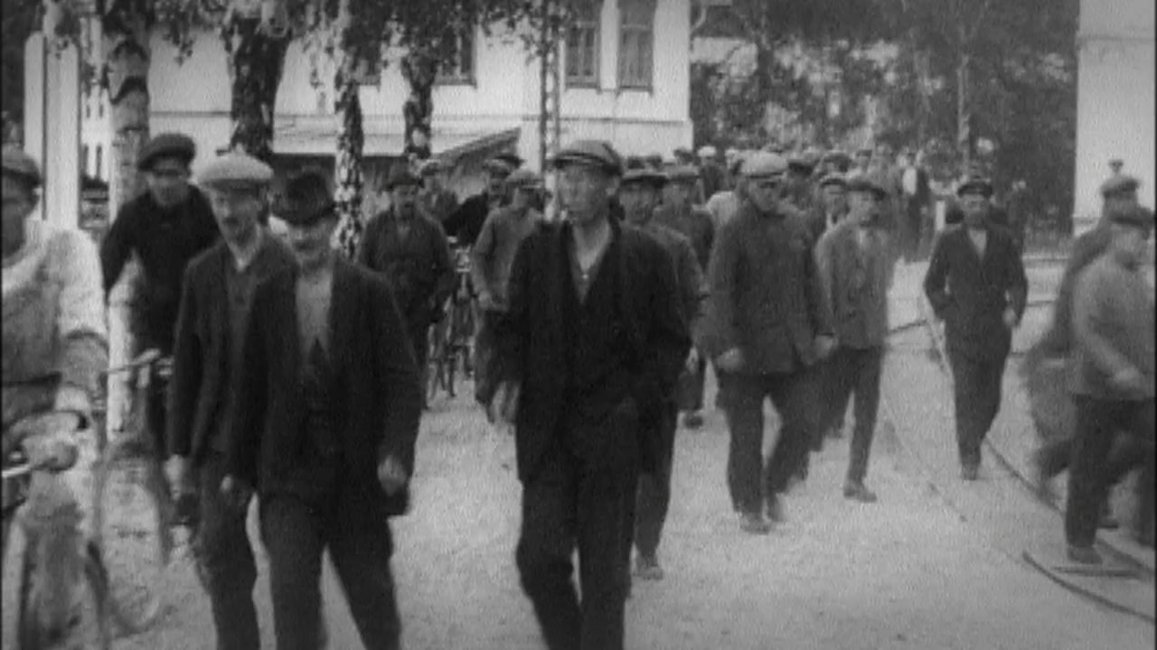 a group of men walking down a street