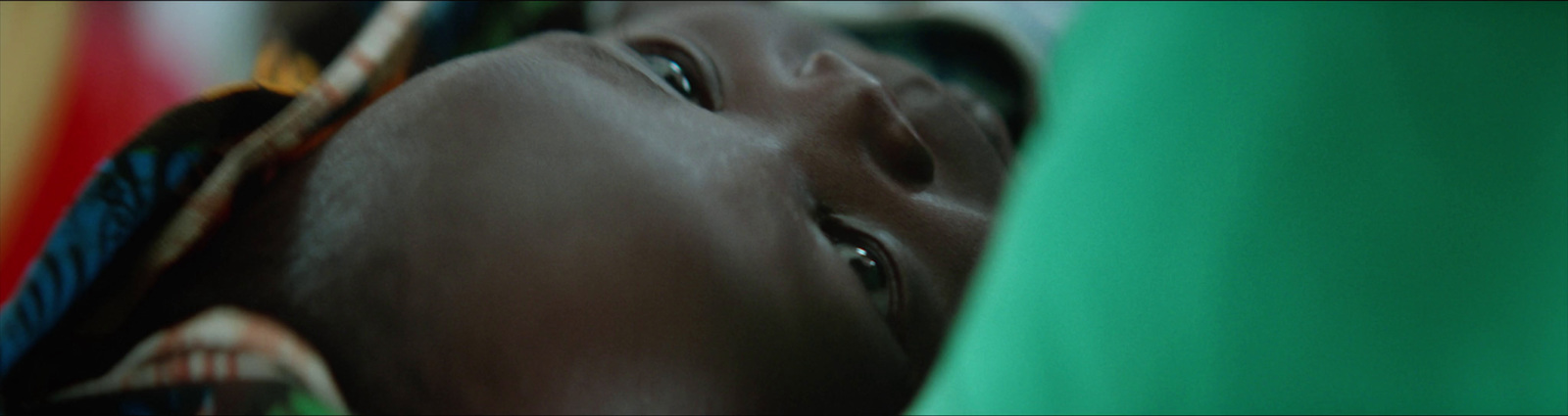 a close up of a person's face and neck