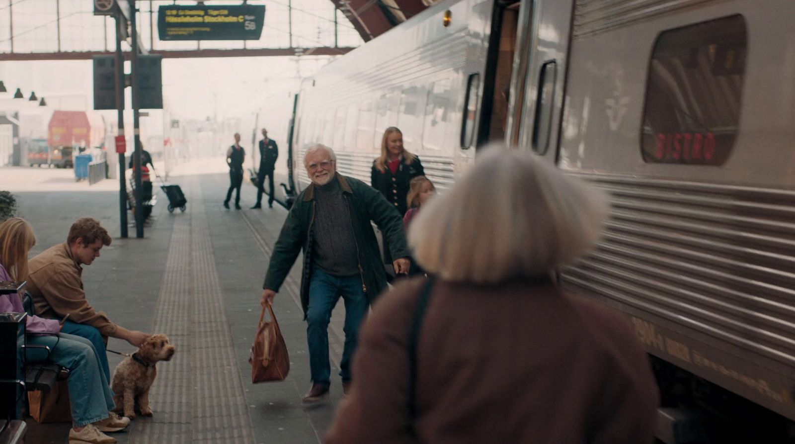 a group of people standing next to a train