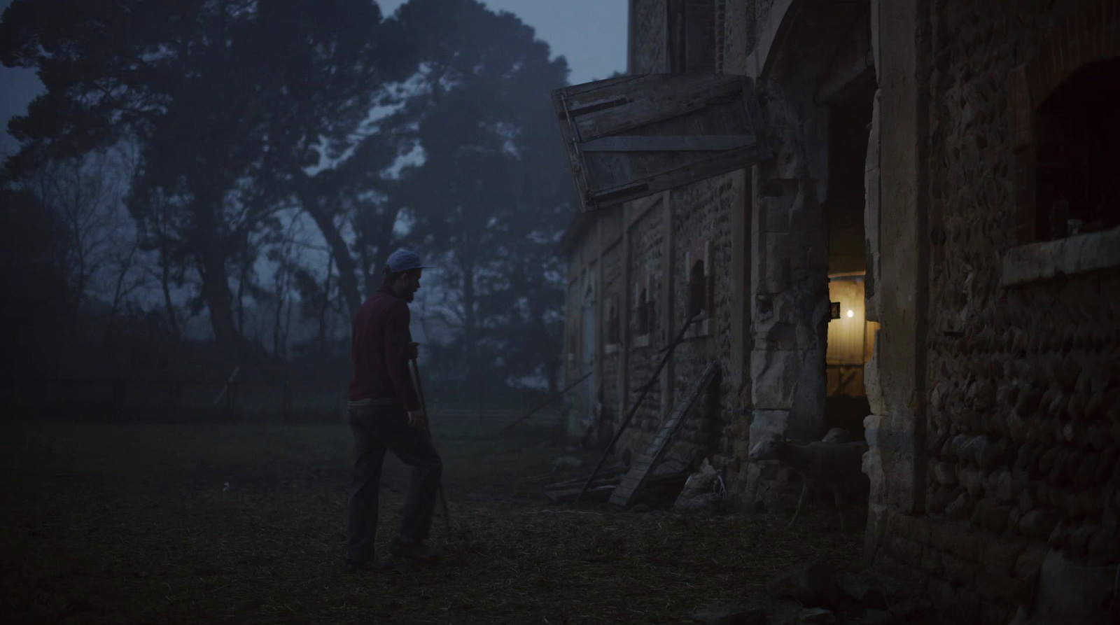 a man standing outside of a building in the dark