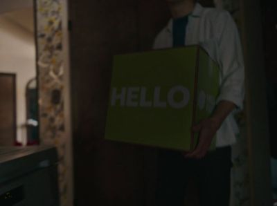 a man holding a box with the word hello on it