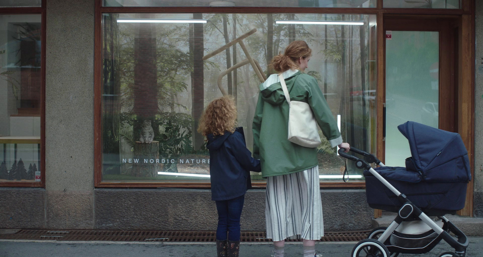 a woman and a child are walking down the street