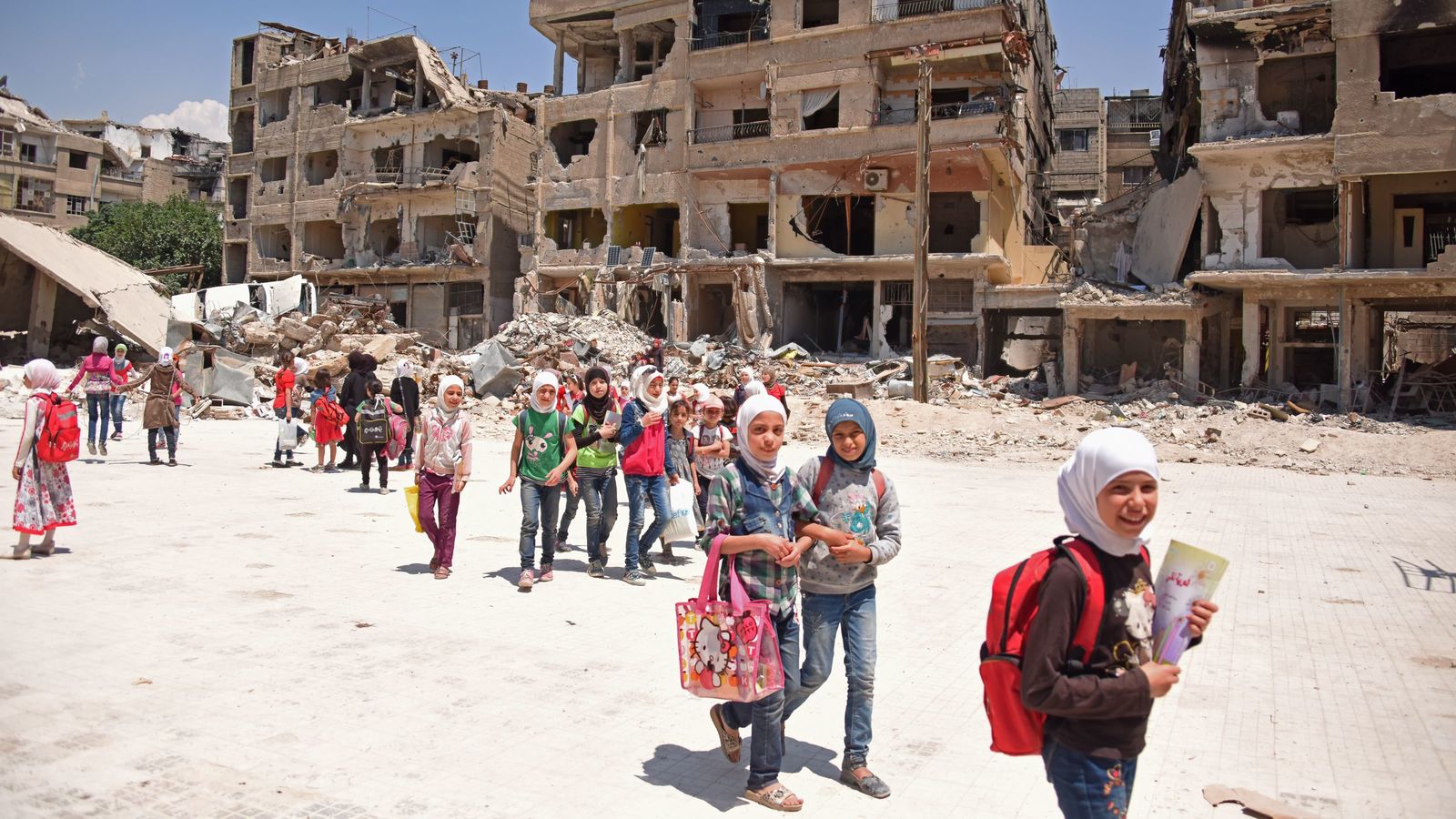 a group of people walking through a dirty city