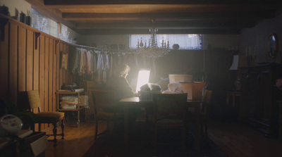 a person sitting at a table in a dark room