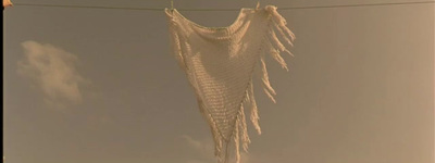 a white blanket hanging from a clothes line