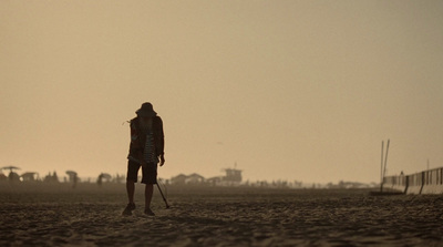 a person standing on a beach with a surfboard