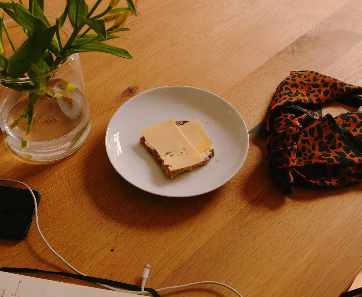 a piece of cake on a plate next to a cell phone