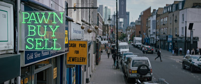 a neon sign that reads pawn buy sell