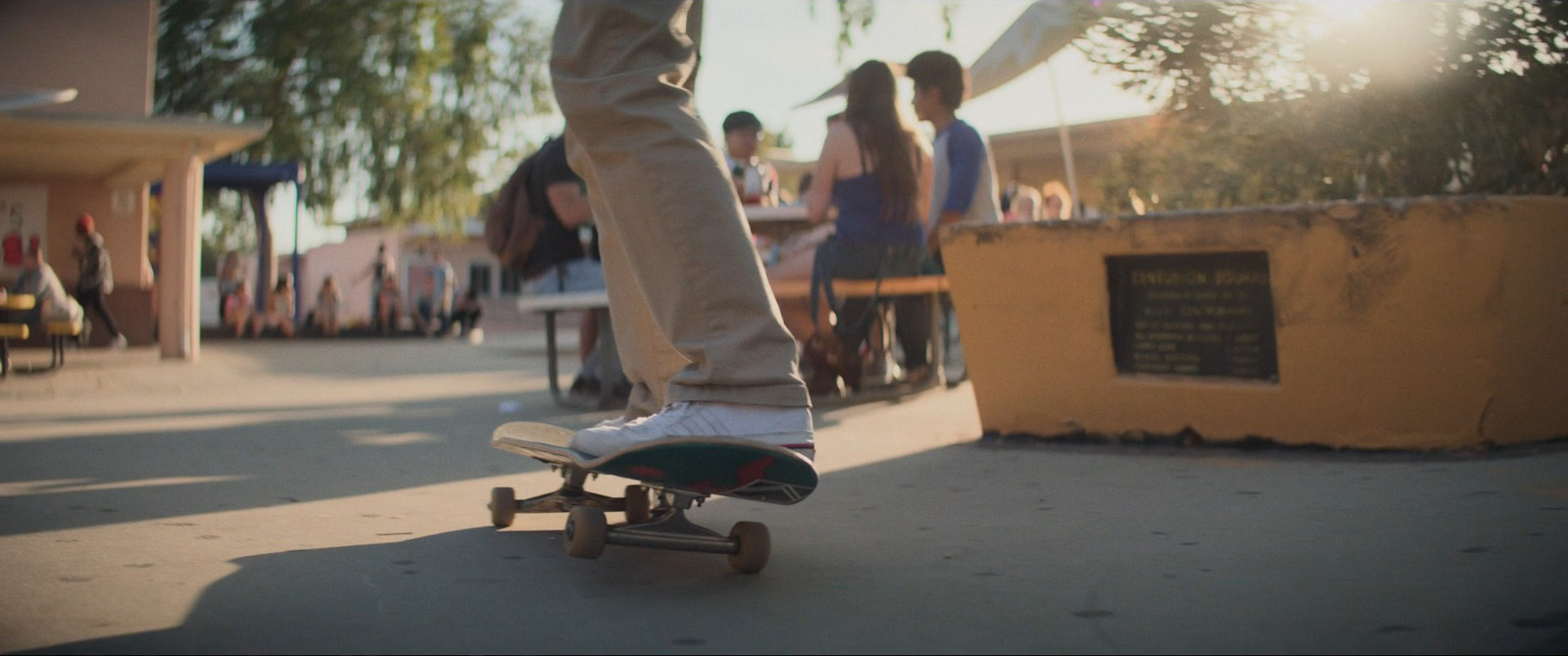 a person riding a skateboard down a sidewalk