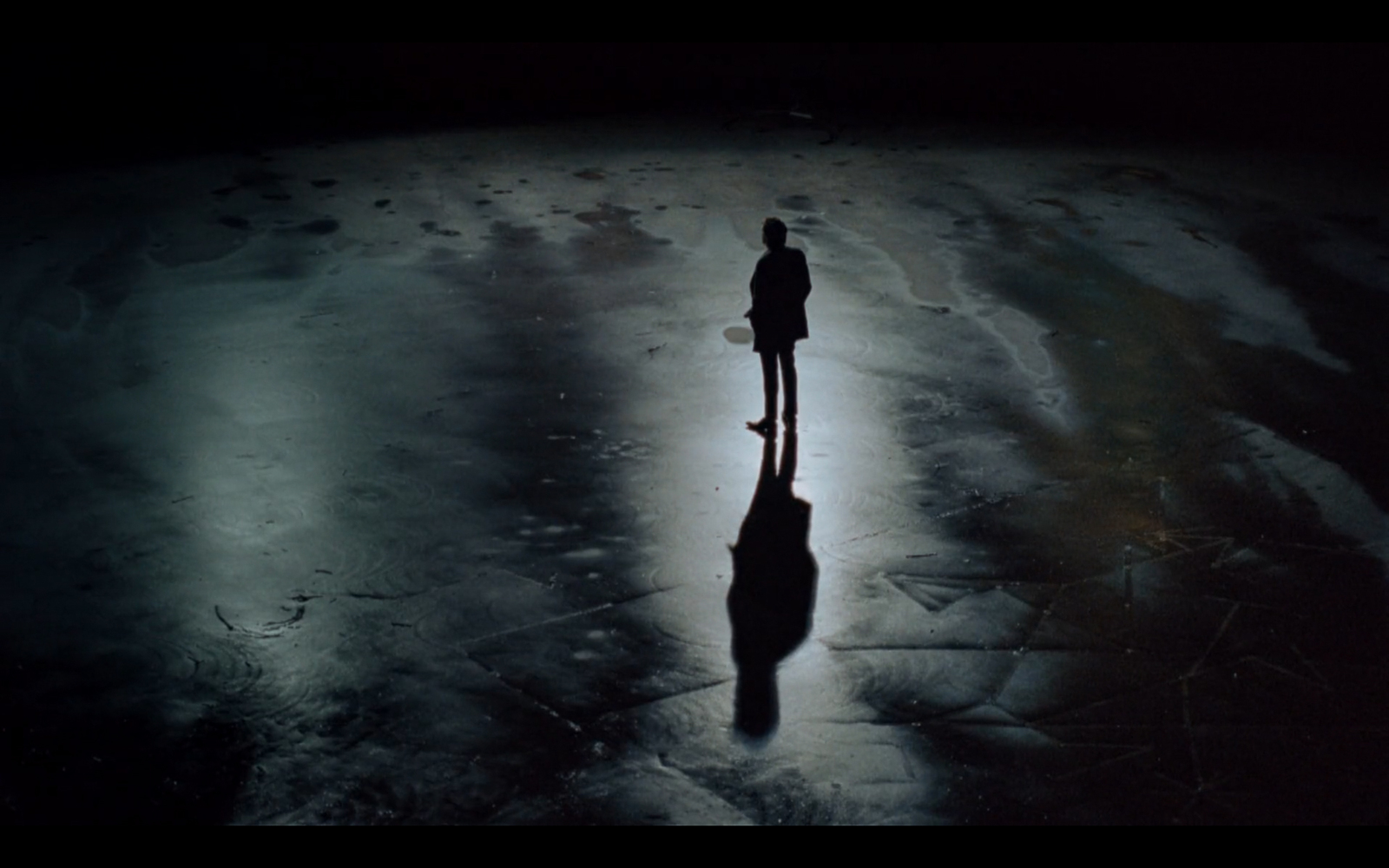 a man standing in the middle of a snow covered ground