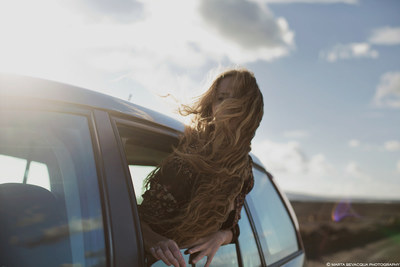 a woman leaning out of a car window