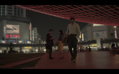 a group of people standing on top of a sidewalk