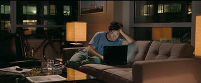 a person sitting on a couch with a laptop