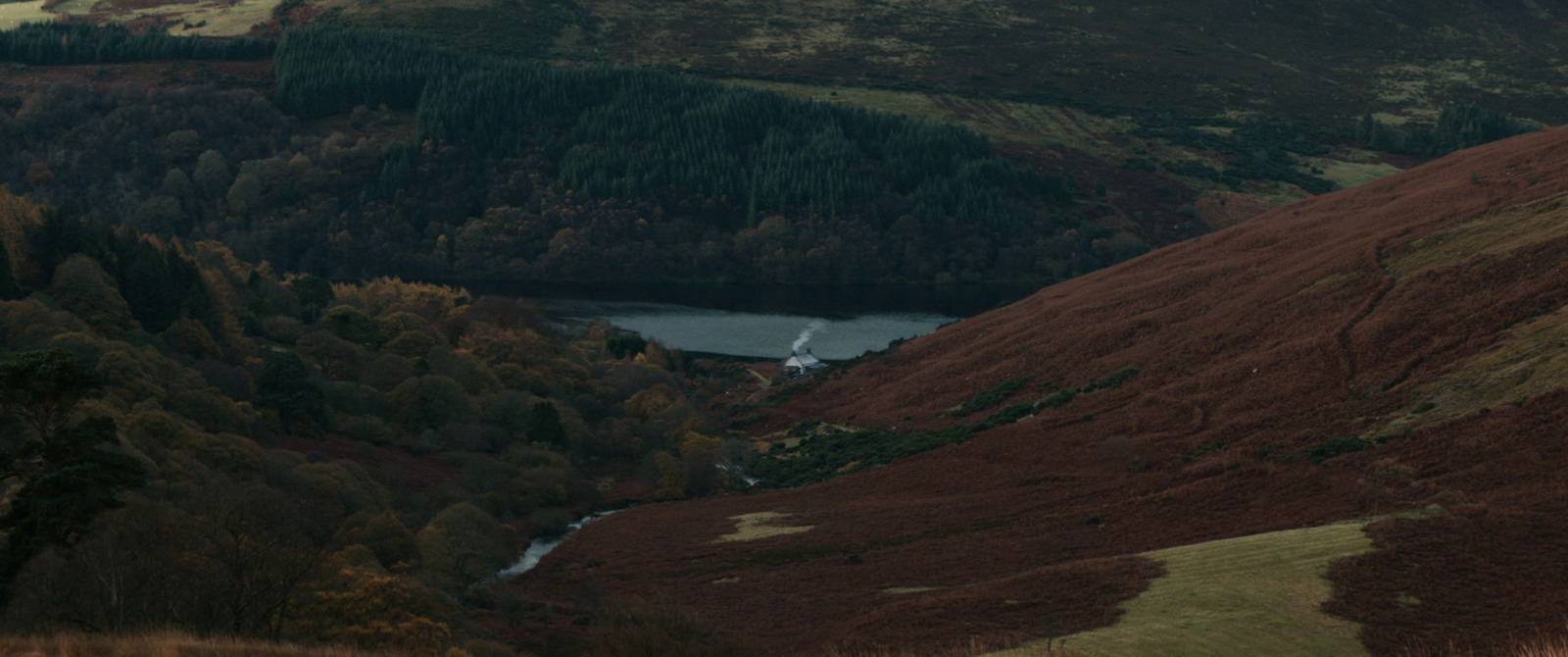 a view of a valley with a river running through it