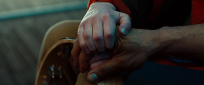 a close up of a person holding the hand of another person