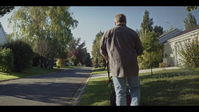 a man is walking down the street with a suitcase