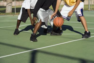 a group of young men standing on top of a basketball court