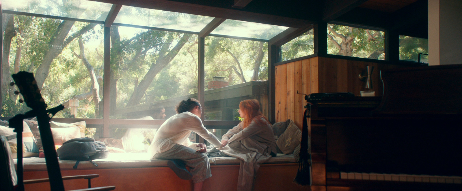 a couple of women sitting on top of a window sill