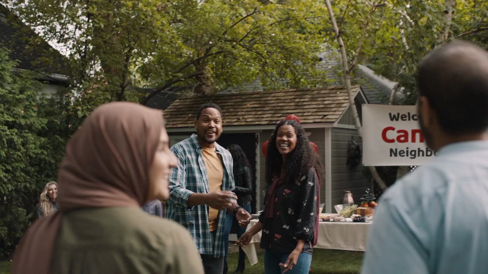 a group of people standing in front of a house