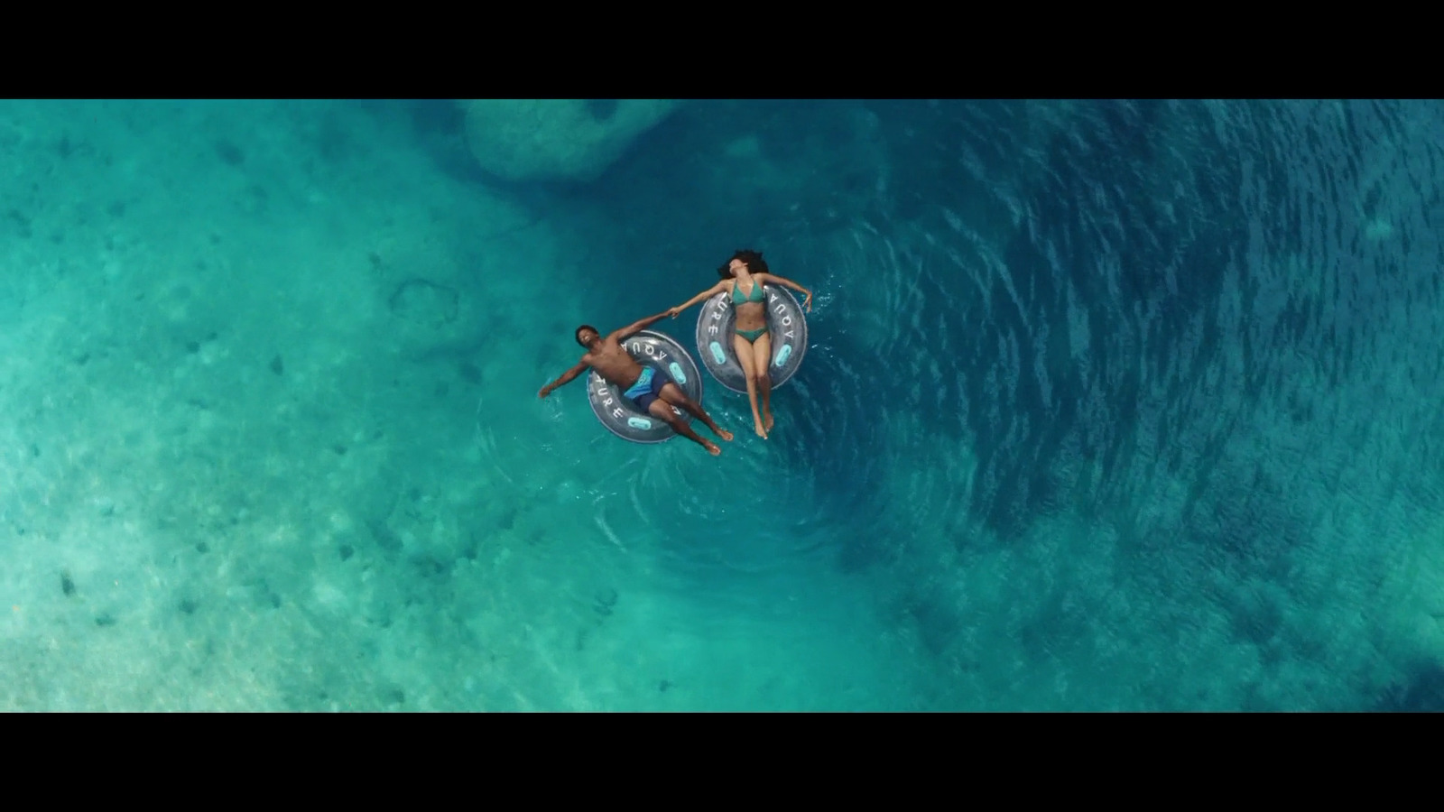 a couple of people riding on the back of a boat