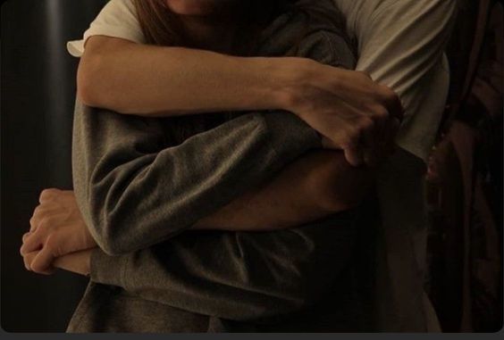 a man and a woman hugging each other