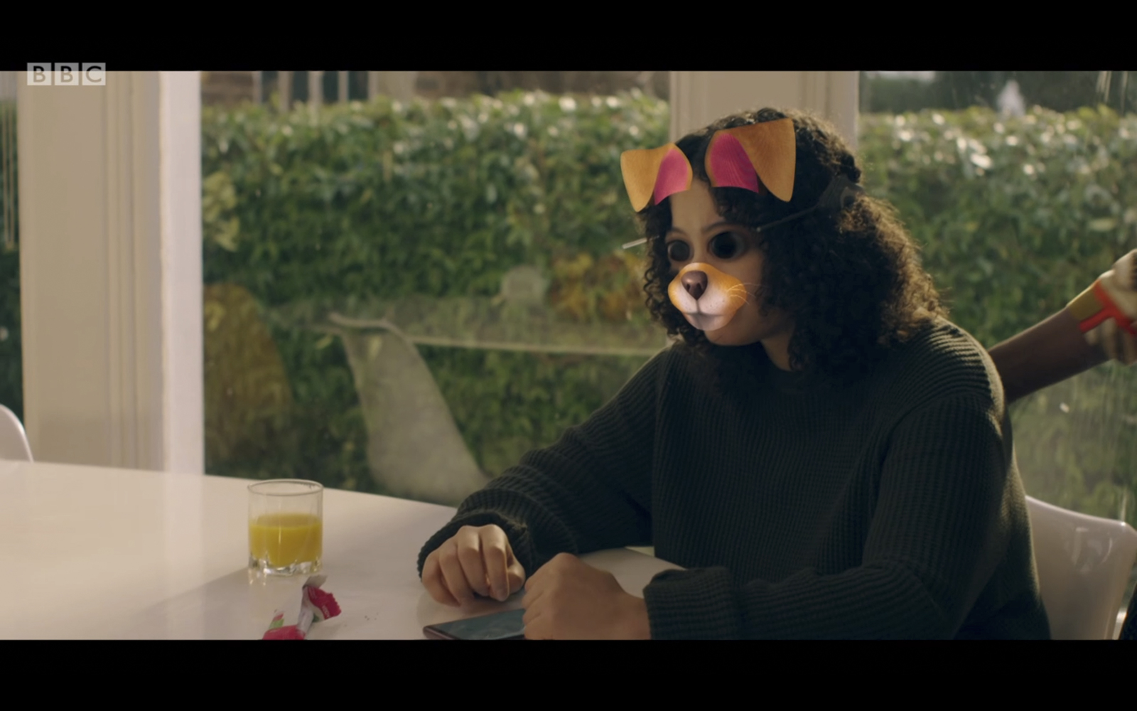 a child wearing a cat costume sitting at a table