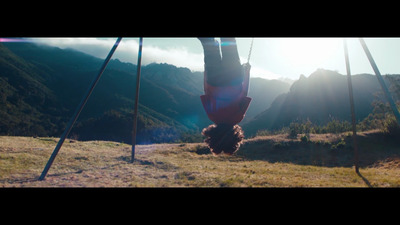 a person hanging upside down on a swing