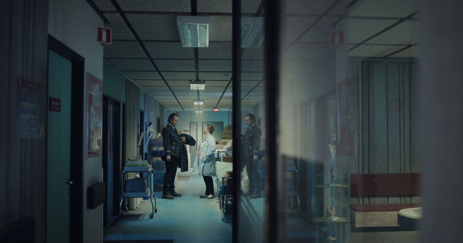 a group of people walking down a hallway